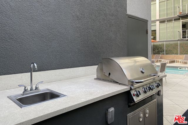 a living room with furniture a flat screen tv and a large window