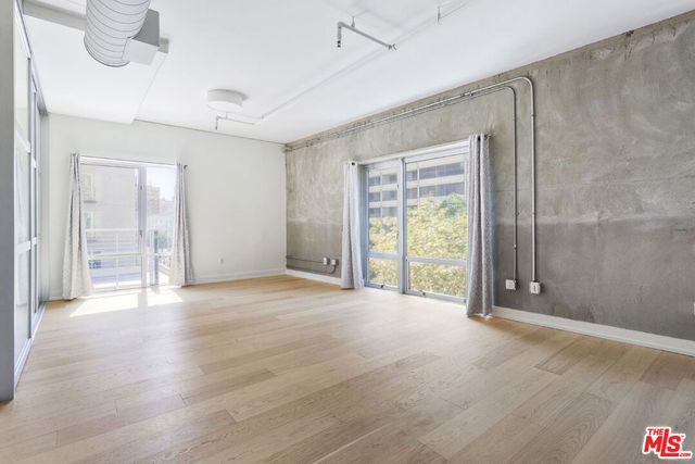 a view of an empty room with glass door
