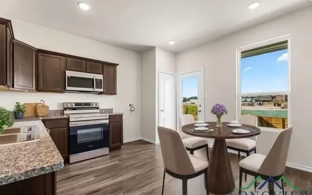 a view of a dining room with furniture and wooden floor