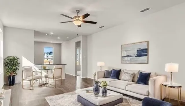 a living room with furniture and a chandelier