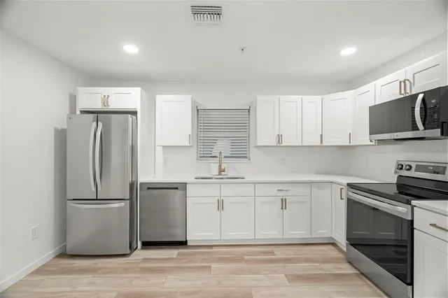 an empty room with wooden floor closet and ceiling fan