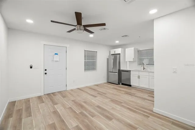 a kitchen with stainless steel appliances granite countertop a refrigerator and a stove top oven