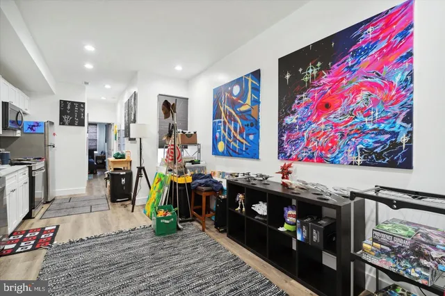 a view of a hallway with wooden floor and windows