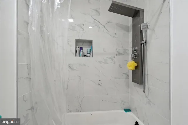 a bathroom with a bathtub and a shower