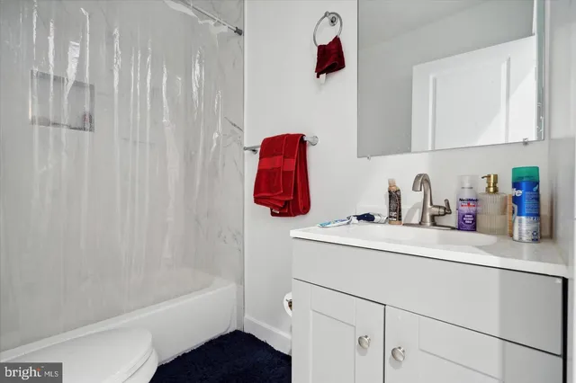 a bathroom with a sink and a shower curtain