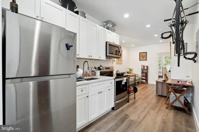 a kitchen with stainless steel appliances a refrigerator stove microwave and sink