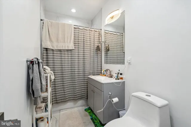 a bathroom with a toilet sink and shower