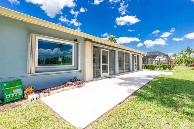 an aerial view of a city with lots of residential buildings ocean and mountain view in back