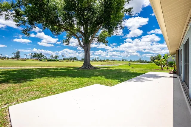 a view of a swimming pool with an outdoor seating and yard