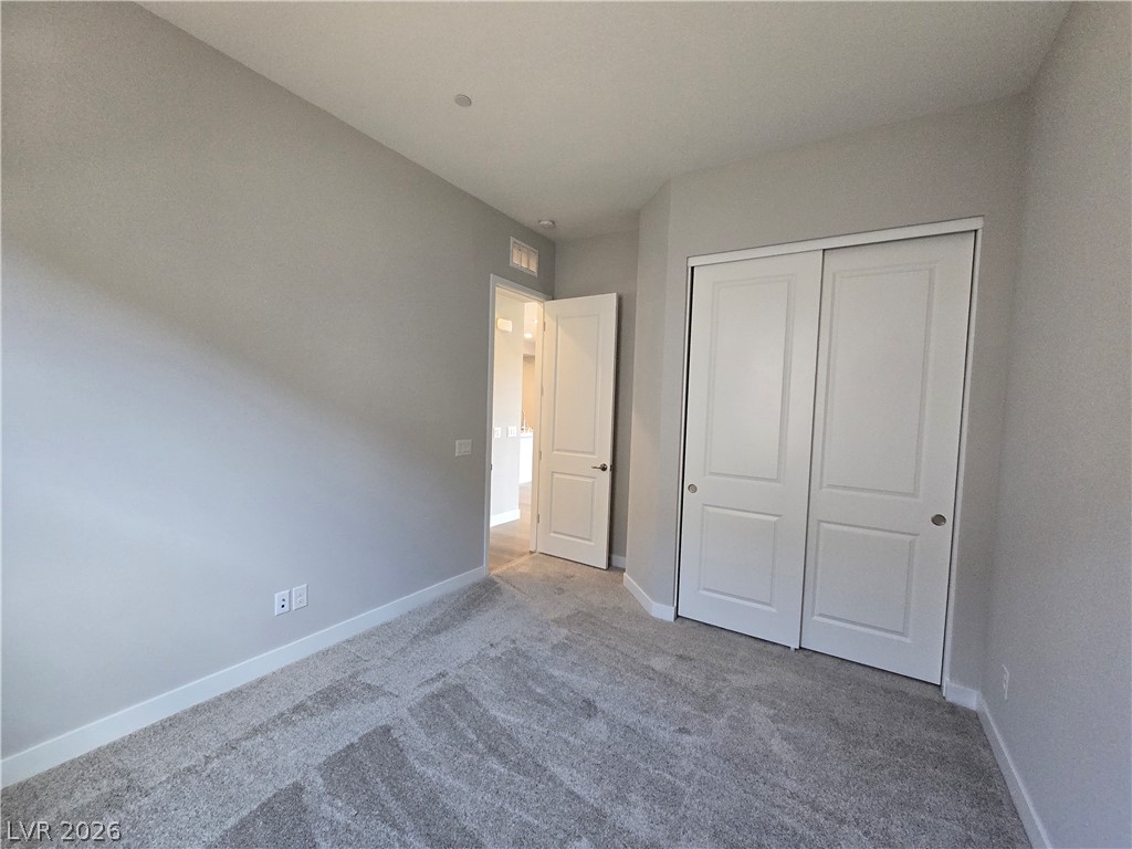 852 Weston Ridge Street Henderson, NV 89011 - Photo 12 of 28 Well-lit and tranquil, this bedroom provides a comfortable, private retreat.