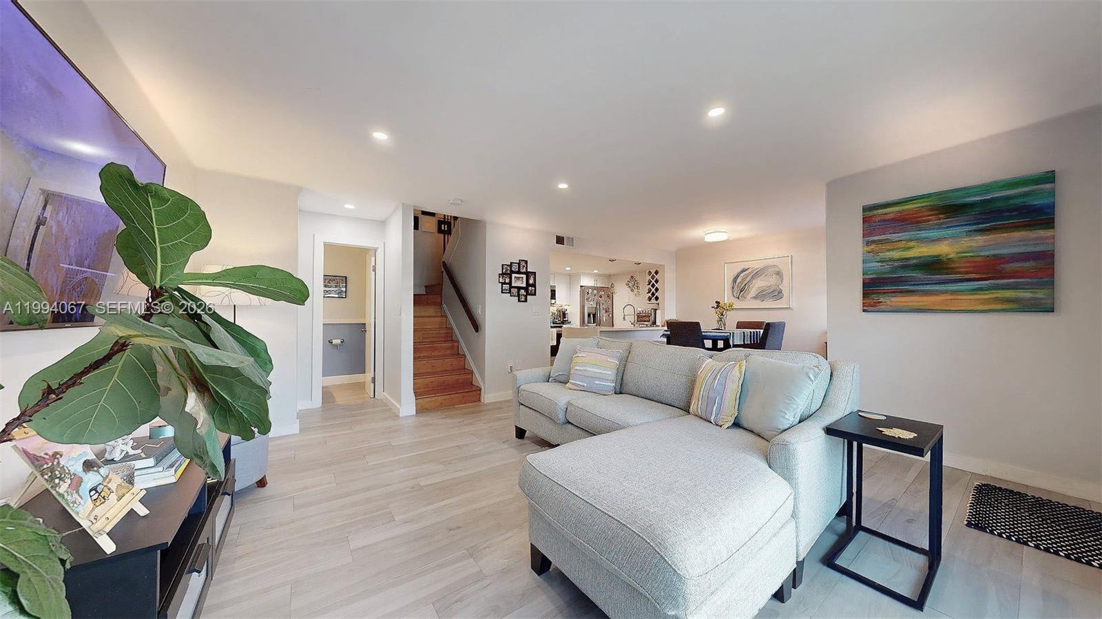 6840 Southwest 45th Lane, Unit 5 Miami, FL 33155 - Photo 11 of 34 a living room with furniture and a wooden floor
