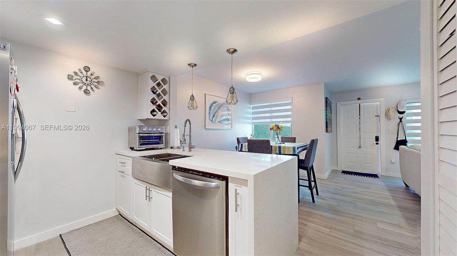 6840 Southwest 45th Lane, Unit 5 Miami, FL 33155 - Photo 16 of 34 a kitchen that has a table and chairs in it