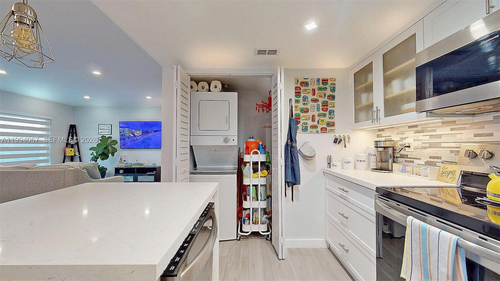 6840 Southwest 45th Lane, Unit 5 Miami, FL 33155 - Photo 17 of 34 a kitchen with stainless steel appliances a sink dishwasher stove and cabinets