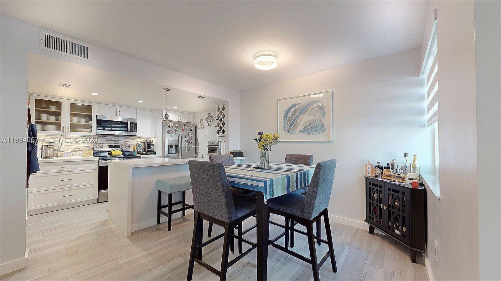 6840 Southwest 45th Lane, Unit 5 Miami, FL 33155 - Photo 18 of 34 a view of a dining room with furniture and wooden floor