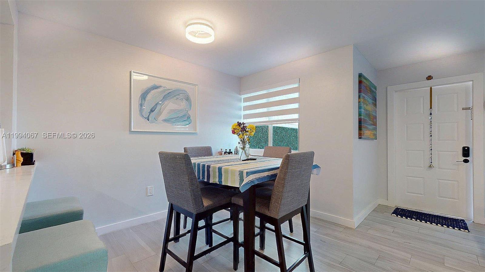 6840 Southwest 45th Lane, Unit 5 Miami, FL 33155 - Photo 19 of 34 a view of a dining room with furniture window and wooden floor