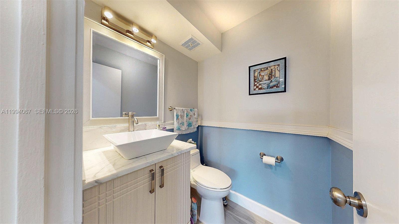 6840 Southwest 45th Lane, Unit 5 Miami, FL 33155 - Photo 21 of 34 a bathroom with a sink mirror vanity and toilet