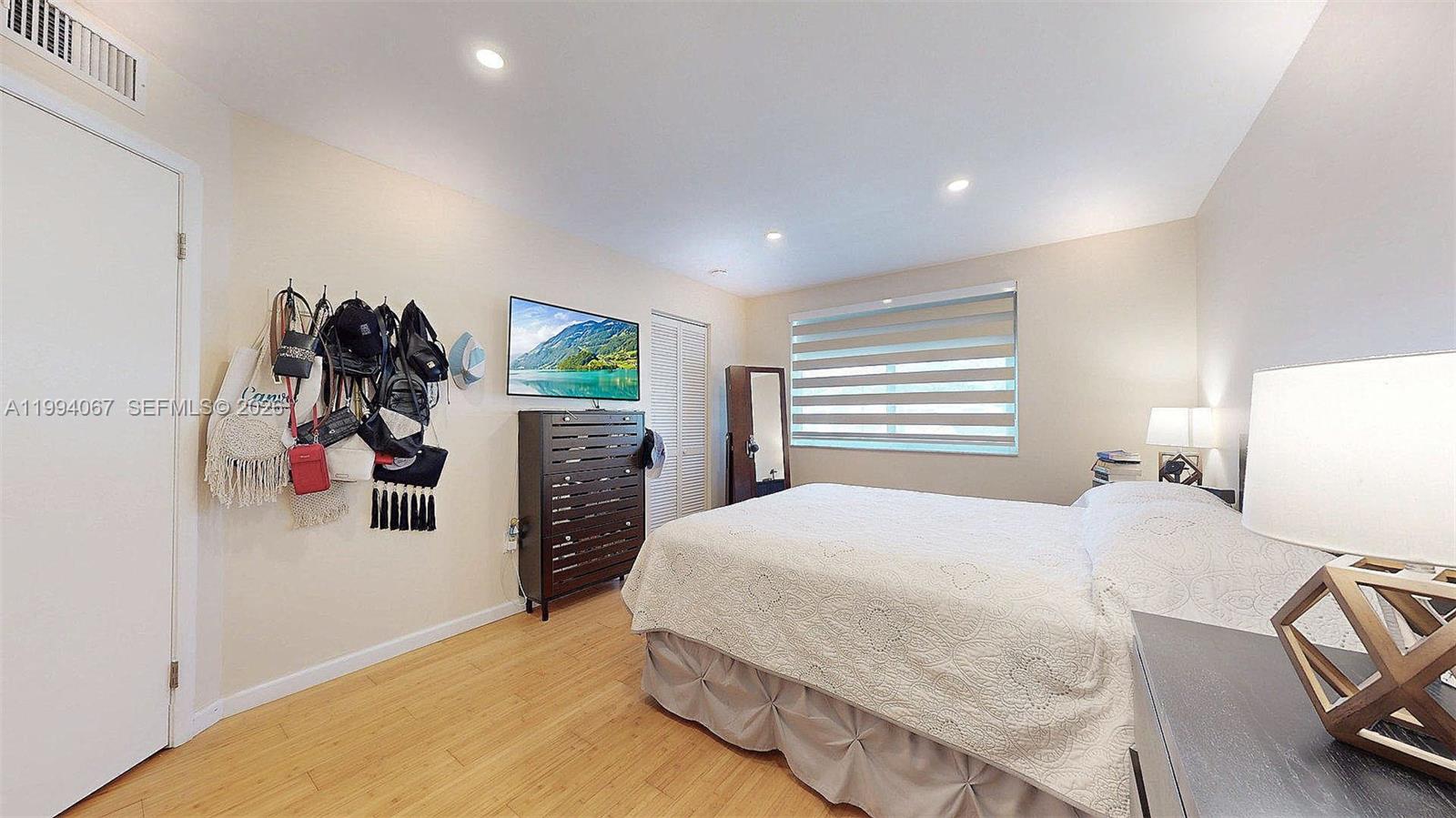 6840 Southwest 45th Lane, Unit 5 Miami, FL 33155 - Photo 25 of 34 a bedroom with a bed and a walk in closet