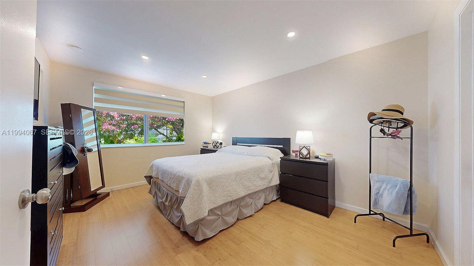 6840 Southwest 45th Lane, Unit 5 Miami, FL 33155 - Photo 26 of 34 a bedroom with a bed and a flat tv screen