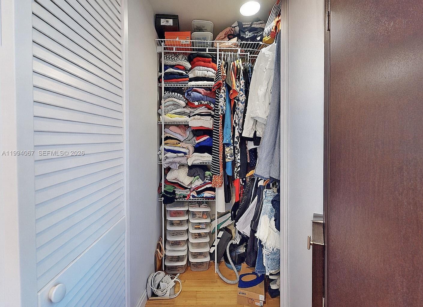6840 Southwest 45th Lane, Unit 5 Miami, FL 33155 - Photo 30 of 34 a view of walk in closet with clothes