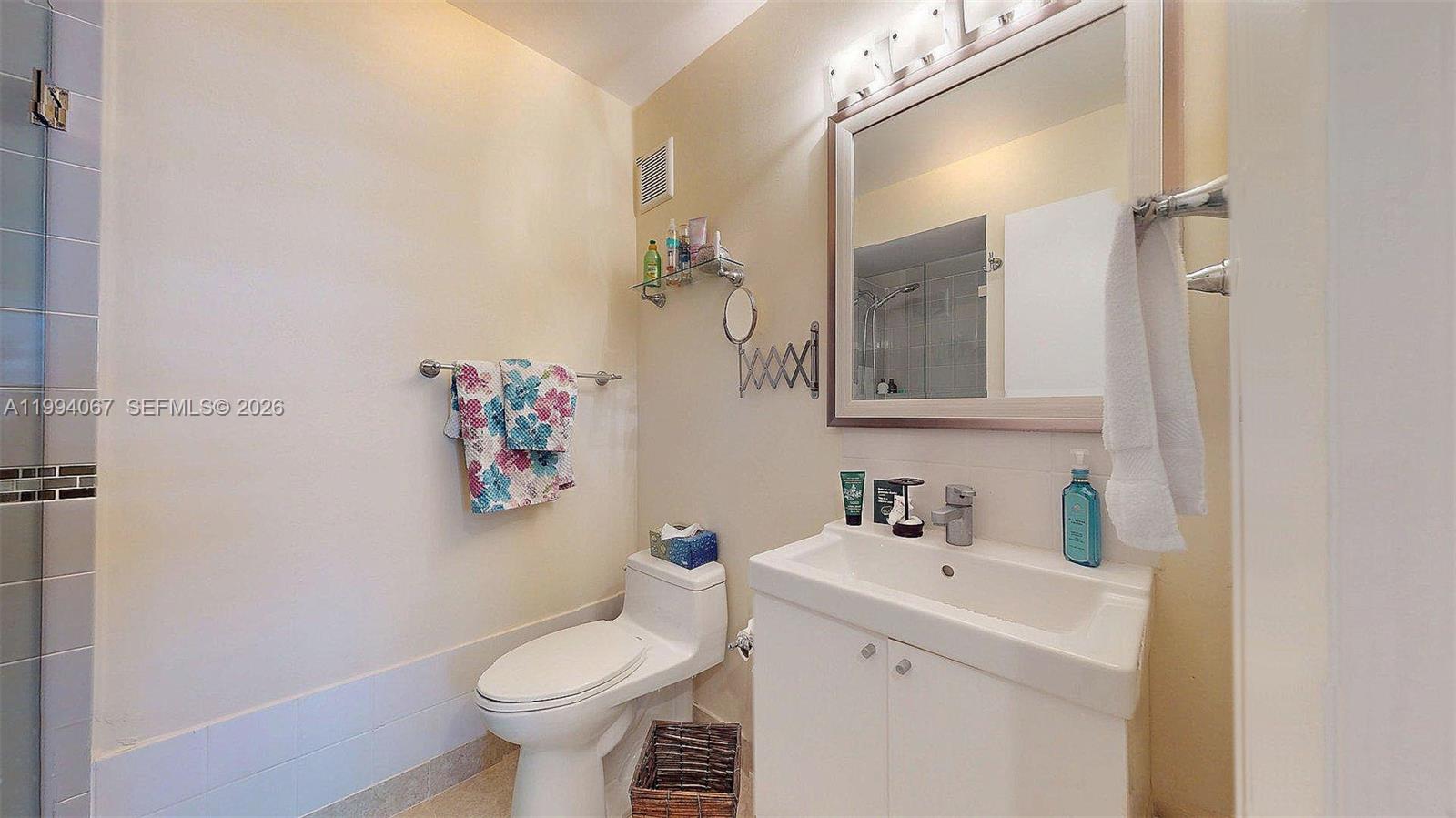 6840 Southwest 45th Lane, Unit 5 Miami, FL 33155 - Photo 34 of 34 a bathroom with a sink toilet and a mirror