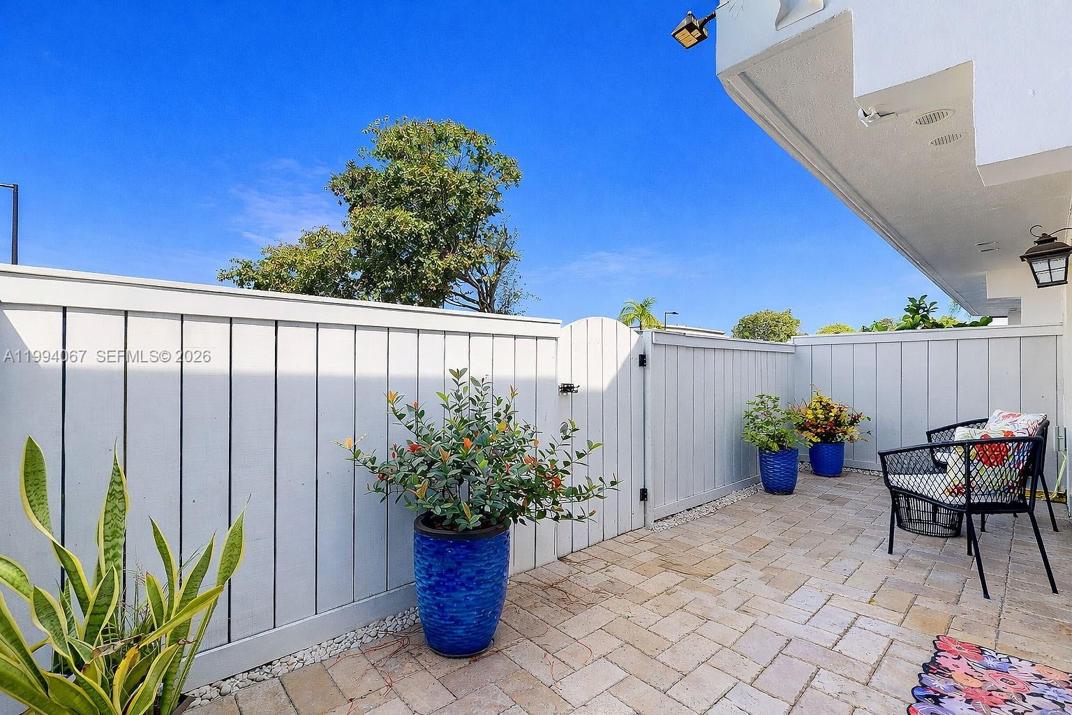 6840 Southwest 45th Lane, Unit 5 Miami, FL 33155 - Photo 4 of 34 a view of a chairs and table in a backyard