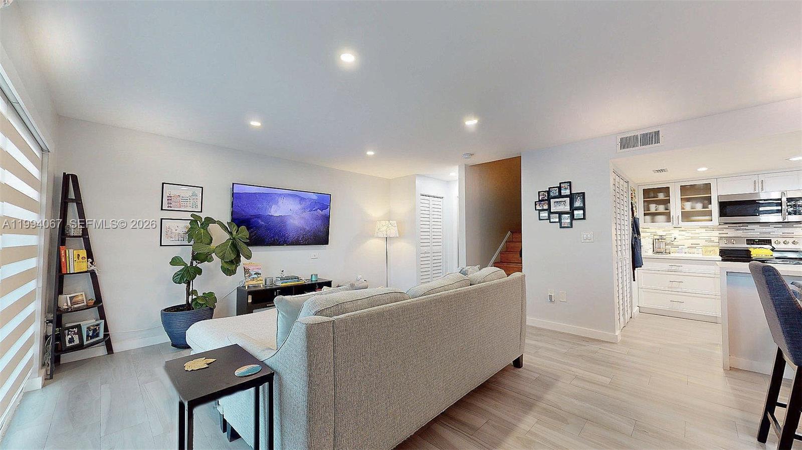 6840 Southwest 45th Lane, Unit 5 Miami, FL 33155 - Photo 6 of 34 a living room with furniture and a flat screen tv