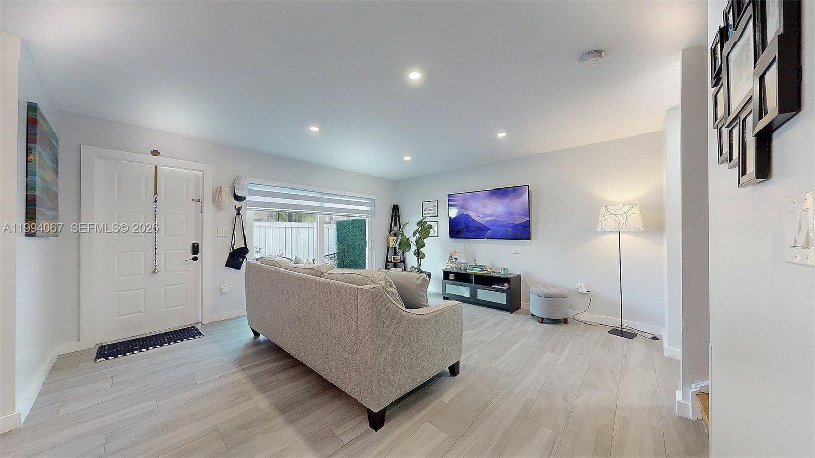 6840 Southwest 45th Lane, Unit 5 Miami, FL 33155 - Photo 7 of 34 a living room with furniture and a flat screen tv