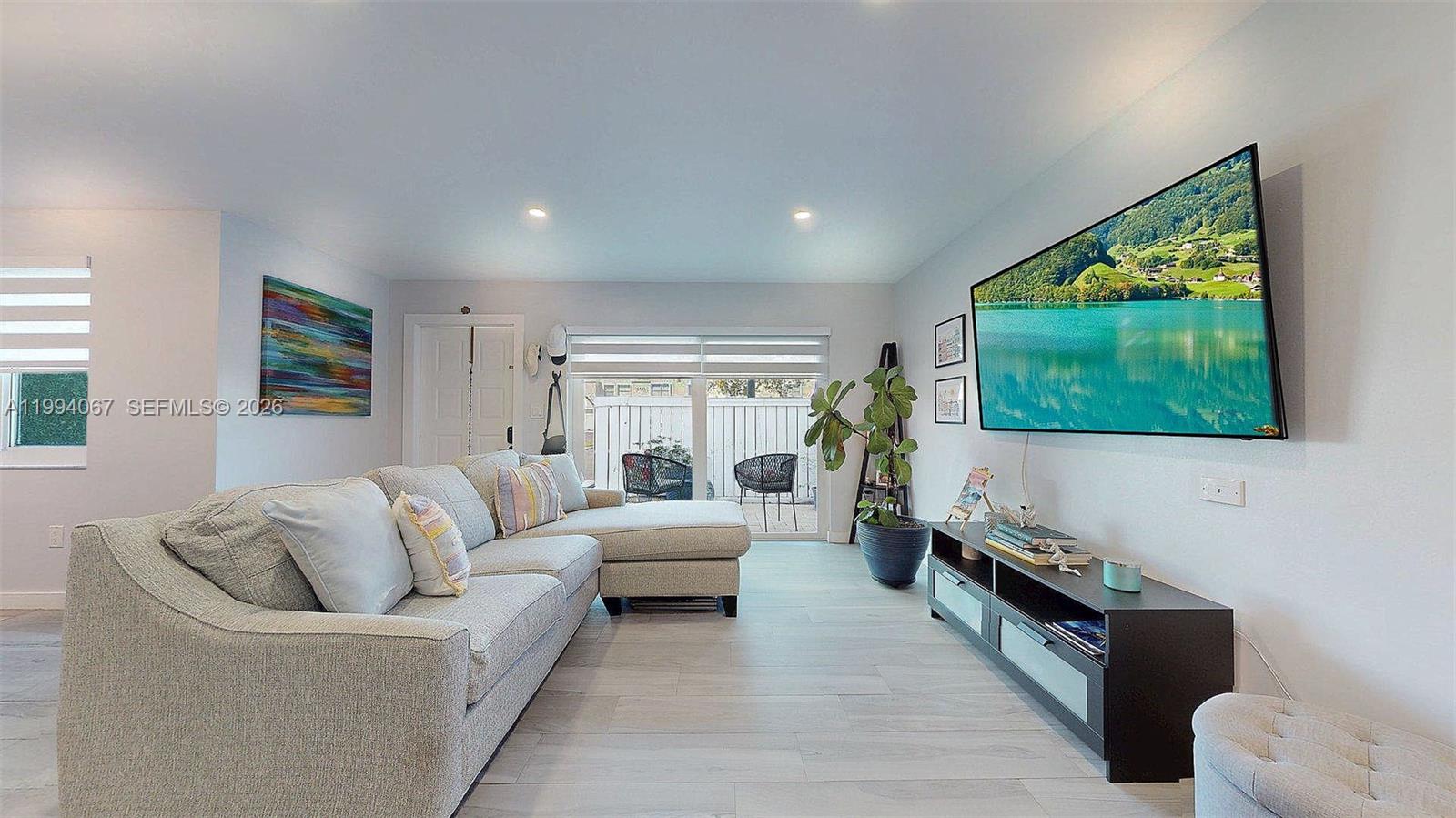 6840 Southwest 45th Lane, Unit 5 Miami, FL 33155 - Photo 10 of 34 a living room with furniture and a flat screen tv