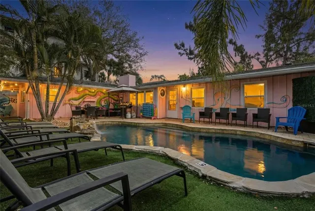 a view of swimming pool with outdoor seating and a yard