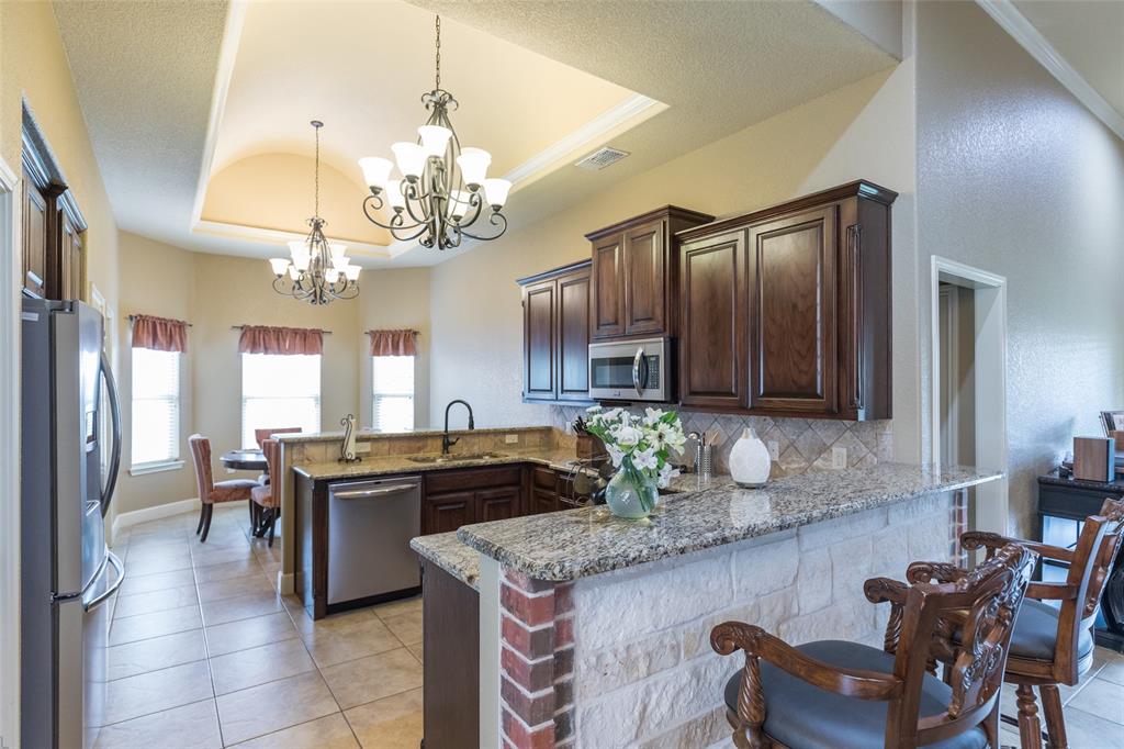 297 Magnum Street Tuscola, TX 79562 - Photo 11 of 35 a kitchen with a table and chairs in it