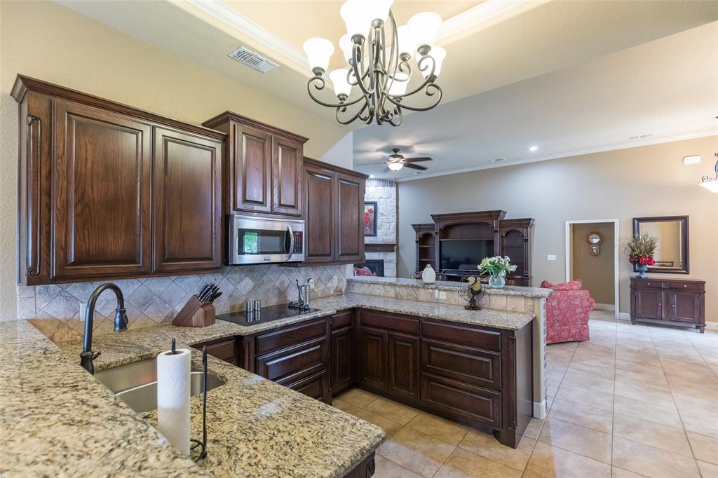 297 Magnum Street Tuscola, TX 79562 - Photo 12 of 35 a kitchen with a refrigerator and a sink