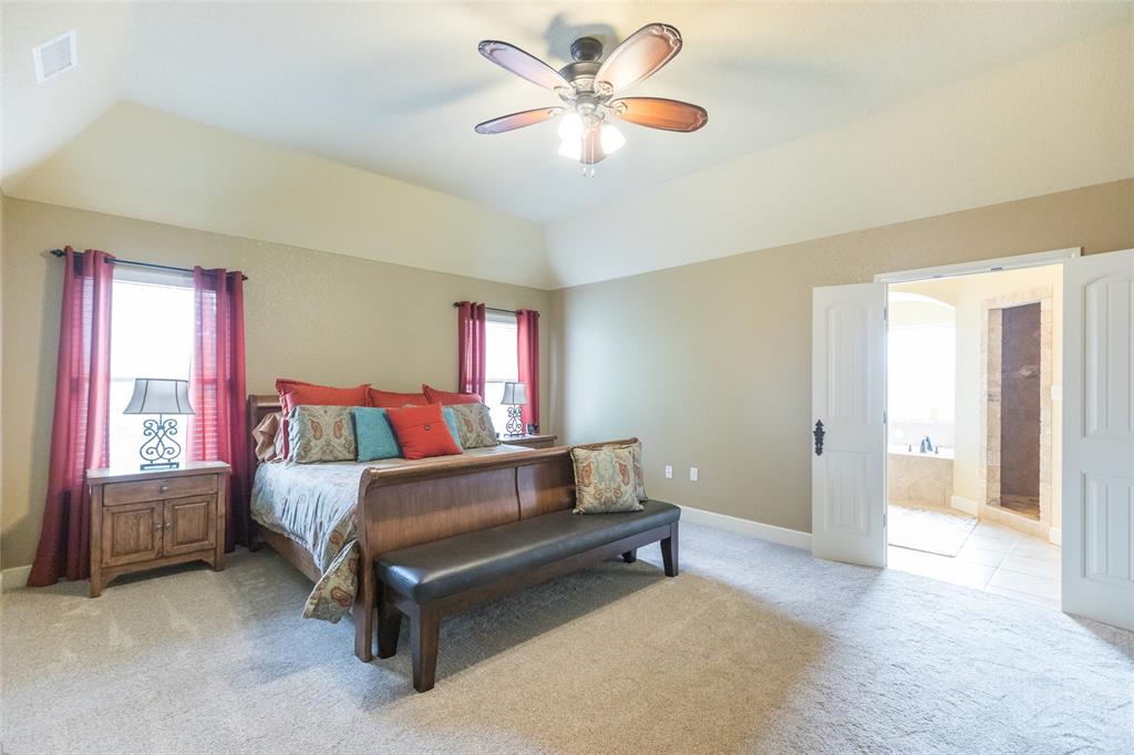 297 Magnum Street Tuscola, TX 79562 - Photo 16 of 35 a bedroom with a bed and a chandelier