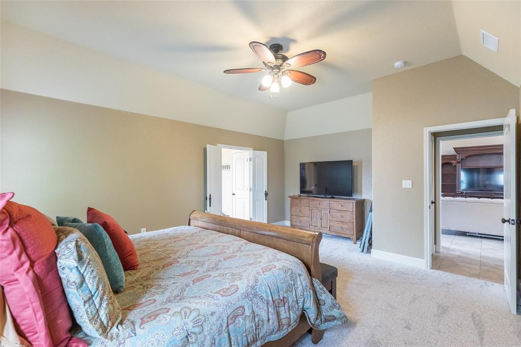297 Magnum Street Tuscola, TX 79562 - Photo 17 of 35 a bedroom with a large bed and a flat screen tv
