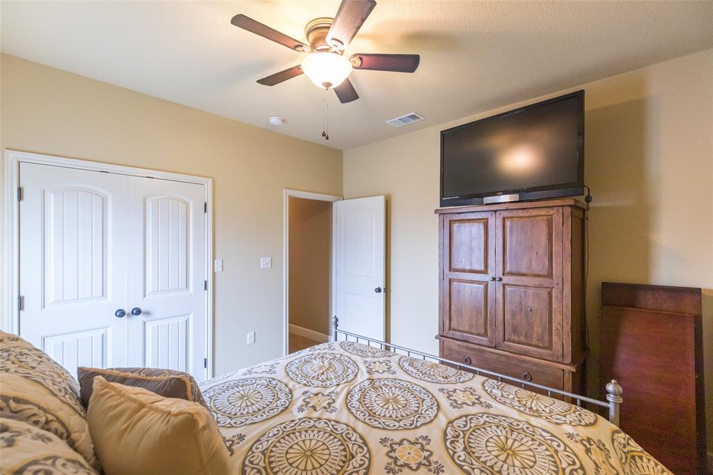297 Magnum Street Tuscola, TX 79562 - Photo 28 of 35 a bedroom with a bed and a flat screen tv