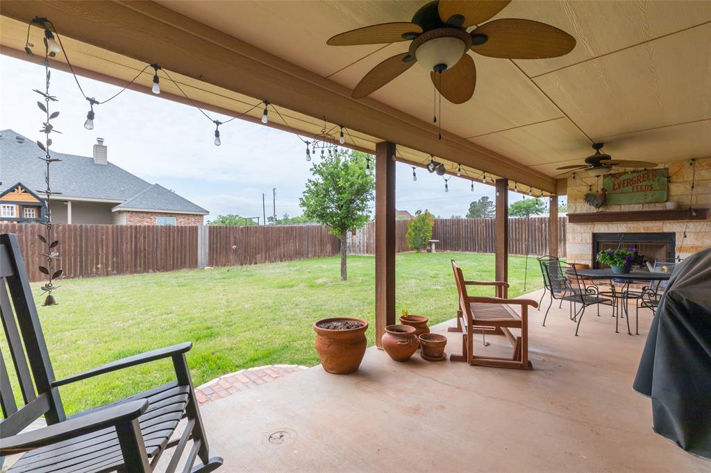 297 Magnum Street Tuscola, TX 79562 - Photo 29 of 35 a view of a patio with a table chairs and a backyard