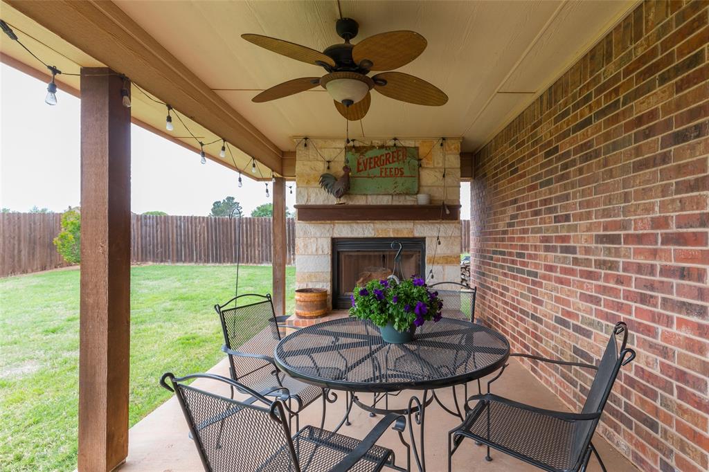297 Magnum Street Tuscola, TX 79562 - Photo 30 of 35 a dining room with furniture a fireplace and a large window