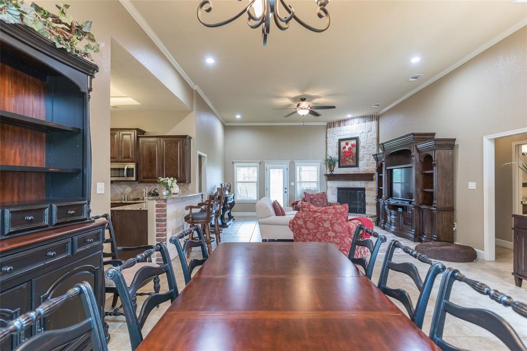 297 Magnum Street Tuscola, TX 79562 - Photo 5 of 35 a view of a dining room with furniture a kitchen and chandelier