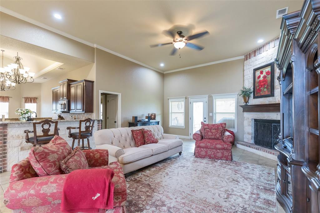 297 Magnum Street Tuscola, TX 79562 - Photo 6 of 35 a living room with furniture and a fireplace