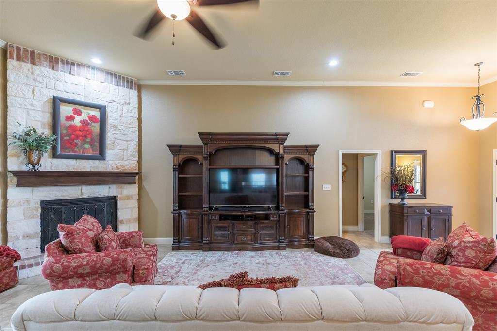 297 Magnum Street Tuscola, TX 79562 - Photo 7 of 35 a living room with furniture and a fireplace