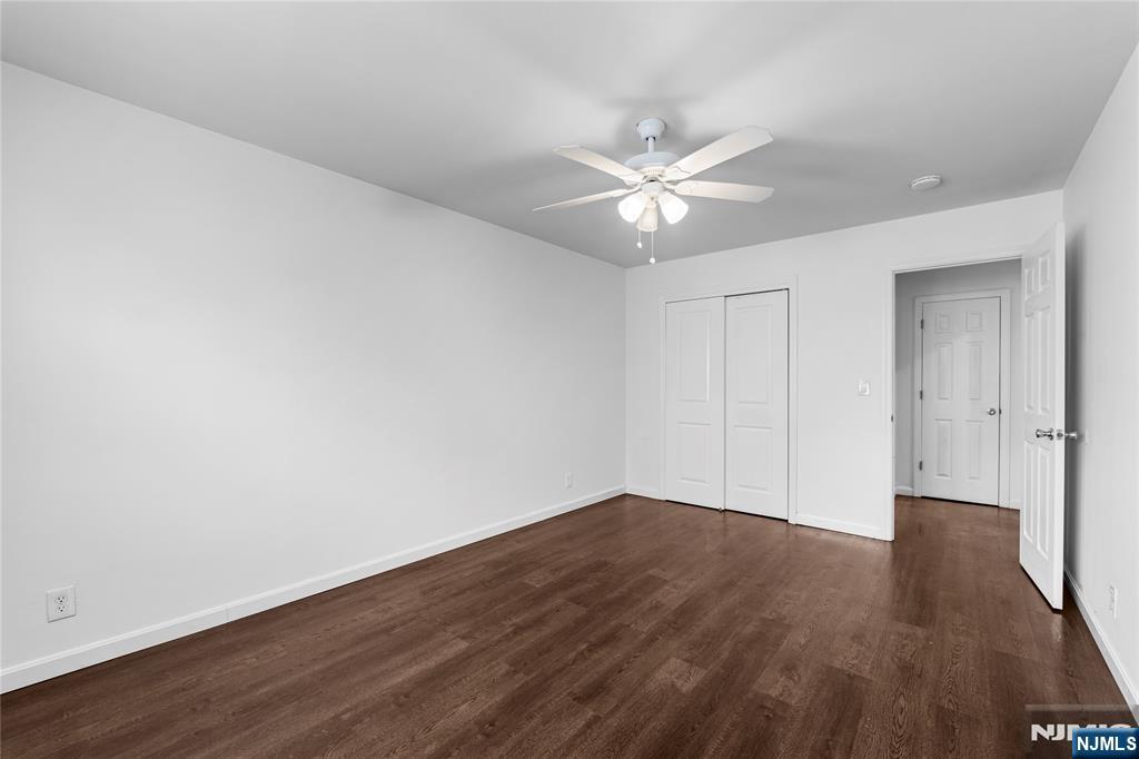 335 Paterson Avenue, Unit F East Rutherford, NJ 07073 - Photo 11 of 12 an empty room with wooden floor and fan