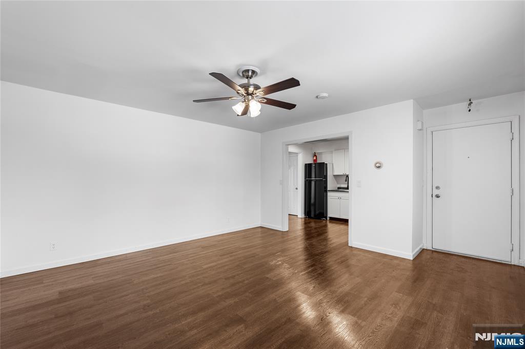 335 Paterson Avenue, Unit F East Rutherford, NJ 07073 - Photo 2 of 12 a view of a livingroom with a ceiling fan and wooden floor
