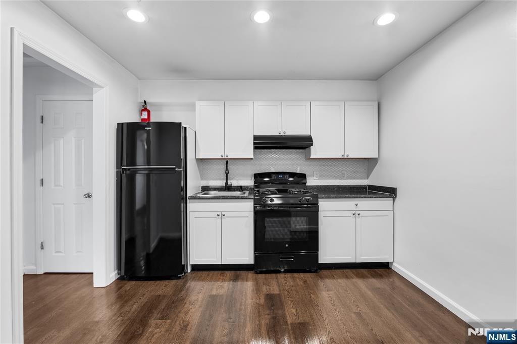 335 Paterson Avenue, Unit F East Rutherford, NJ 07073 - Photo 4 of 12 a kitchen with a refrigerator and a stove top oven
