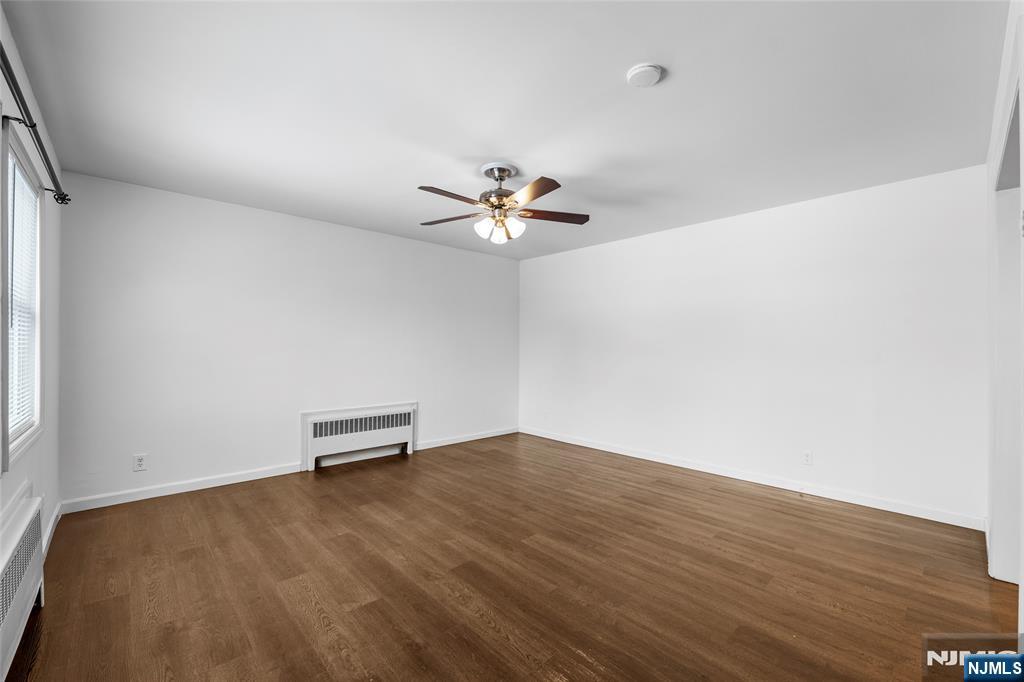 335 Paterson Avenue, Unit F East Rutherford, NJ 07073 - Photo 7 of 12 wooden floor in an empty room with a window
