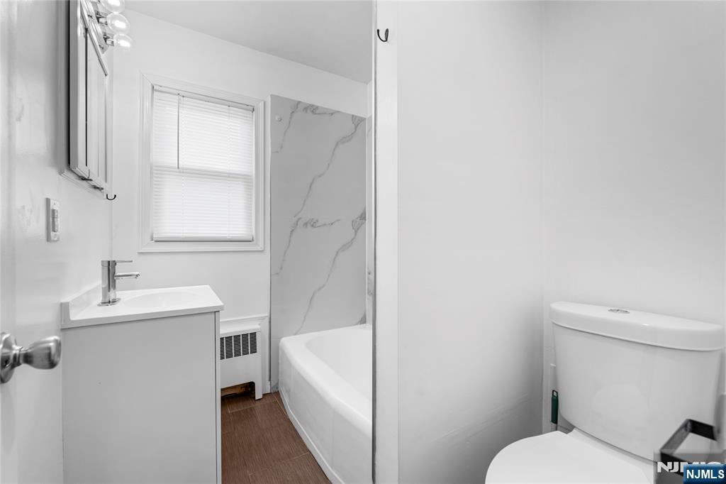 335 Paterson Avenue, Unit F East Rutherford, NJ 07073 - Photo 10 of 12 a bathroom with a sink a toilet and tub