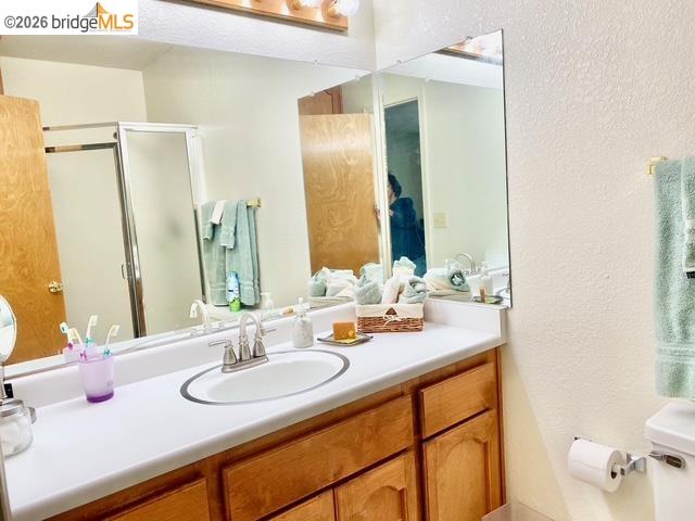 13133 Mohrmann Street Groveland, CA 95321 - Photo 19 of 55 a bathroom with double vanity sinks a toilet and a mirror