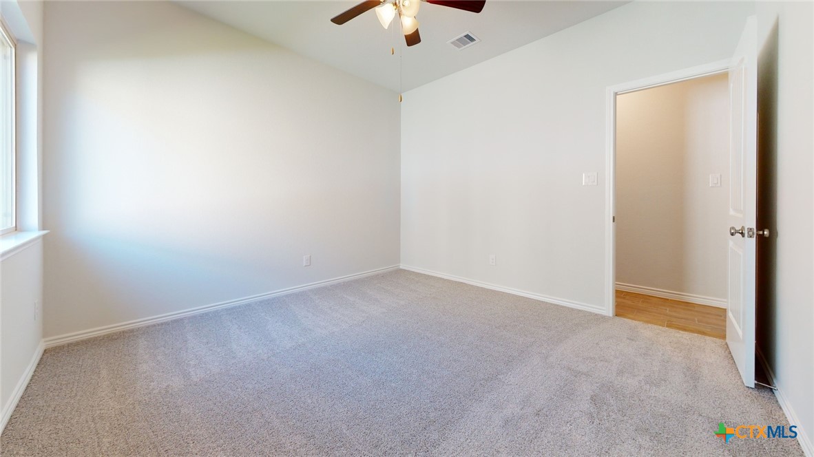 14089 Carsten Loop Salado, TX 76571 - Photo 13 of 17 an empty room with a ceiling fan and carpet