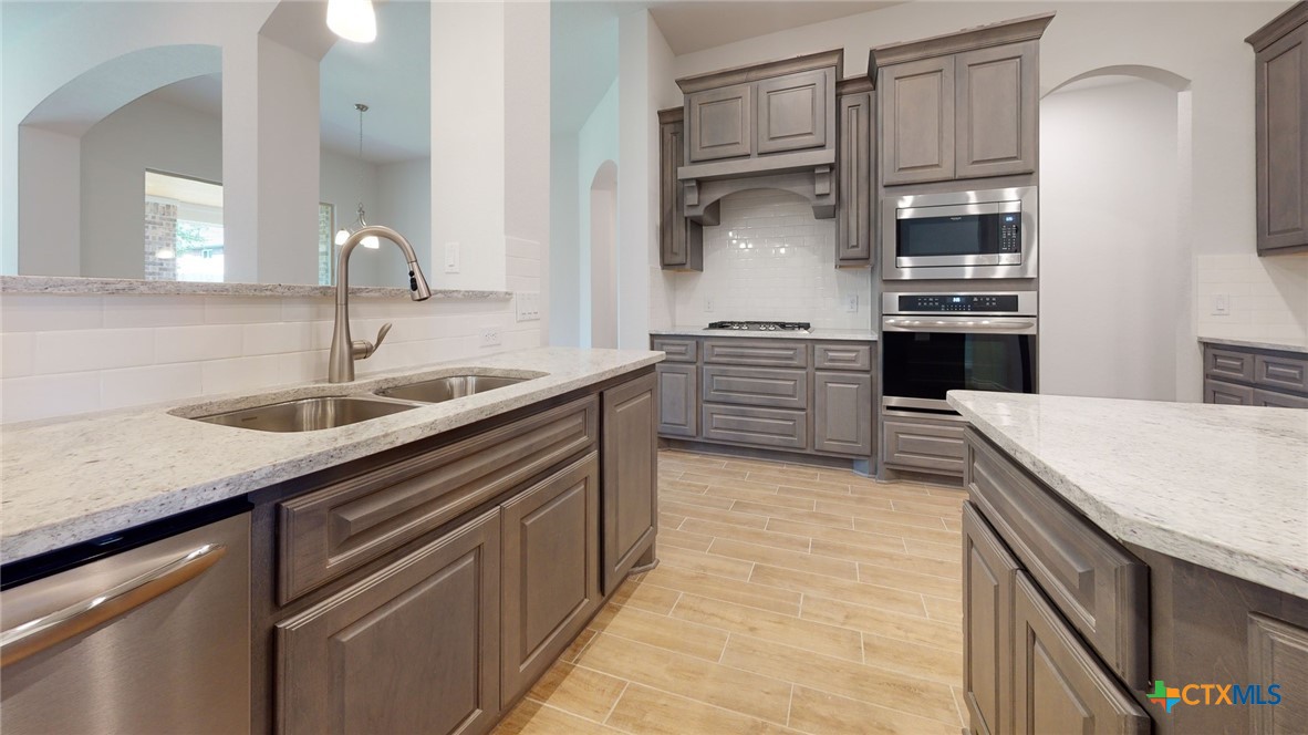 14089 Carsten Loop Salado, TX 76571 - Photo 4 of 17 a kitchen with stainless steel appliances granite countertop a sink and cabinets