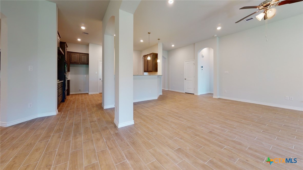 14089 Carsten Loop Salado, TX 76571 - Photo 8 of 17 a view of a hallway with wooden floor and a bathroom