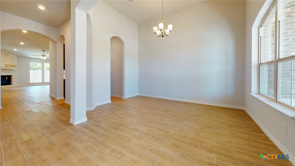 14089 Carsten Loop Salado, TX 76571 - Photo 9 of 17 an empty room with chandelier fan and windows