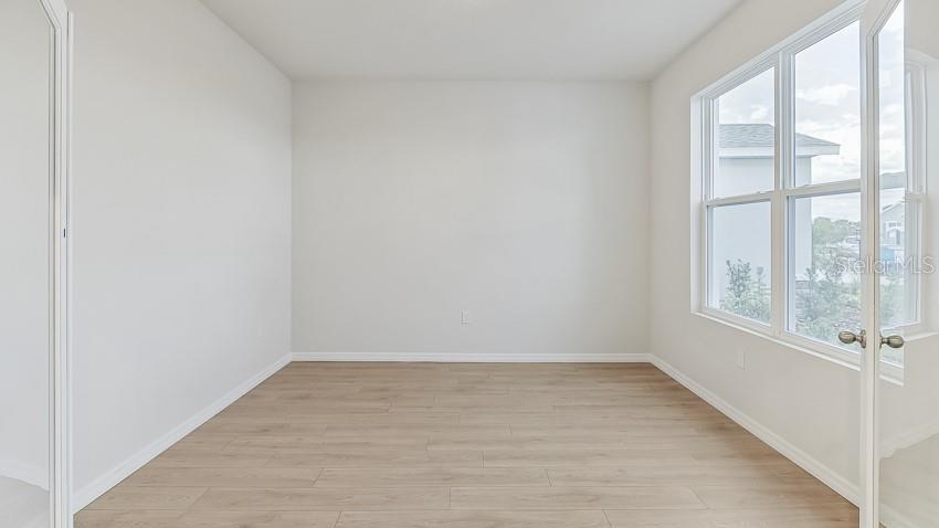 1925 Cobb Trail Parrish, FL 34219 - Photo 3 of 25 wooden floor in an empty room with a window